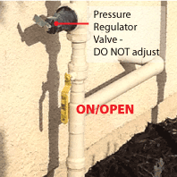 Ball Valve to turn water on/off in open position; warning to not touch pressure regulator.